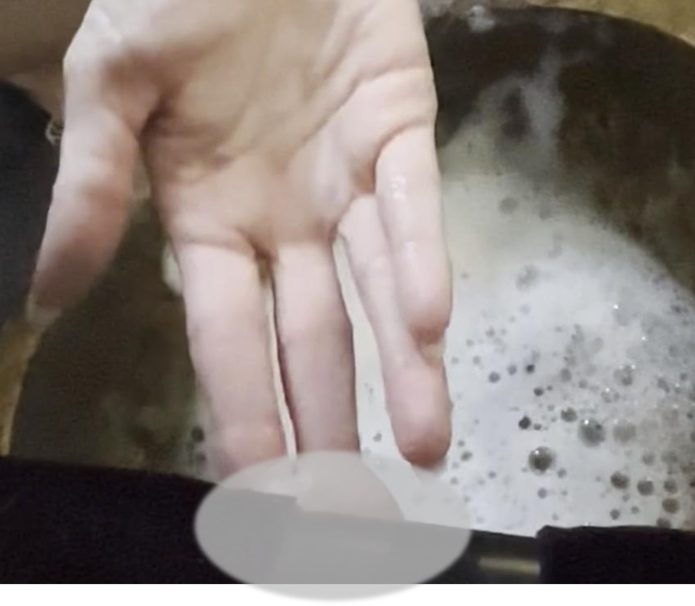 Francesca's finger tip touches the end of her clients erect penis after she has rinsed the soap of it